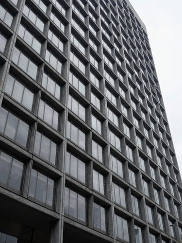 Wide architectural detail of a modern corporate building facade in São Paulo, sharp lines, slate gray and steel, soft overcast daylight, generous negative space.