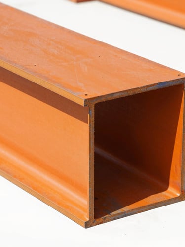 Close-up on heavy-duty structural steel joints, safety-orange painted steel finish, bright workshop lighting, high-contrast realistic tones, sharp focus