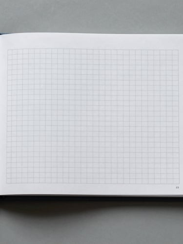 Straight-on orthographic projection of a highly structured brand guideline book on a cool gray surface, sharp technical grid lines visible, flat studio lighting.