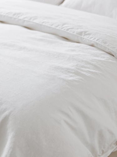 Macro shot of premium white cotton bedding weave, showcasing fine thread density and elegant texture, soft natural lighting, shallow depth of field