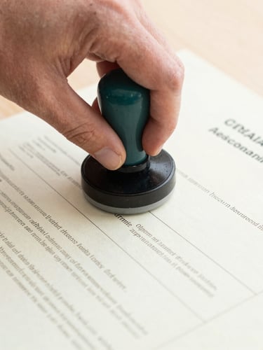 Close-up of a professional hand placing an official embossed stamp on a validated academic transcript, bright natural daylight, neutral tones, sharp focus, 35mm
