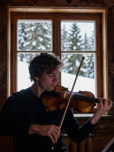 Intimate close-up of a classical violinist rehearsing inside a rustic timber cabin, natural alpine daylight streaming through a large window showing snow-dusted pine trees, deep rich wood tones, dramatic documentary photography.