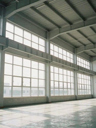 Symmetrical architectural shot of a clean industrial facility interior, bright daylight streaming through high windows, steel structures, 35mm