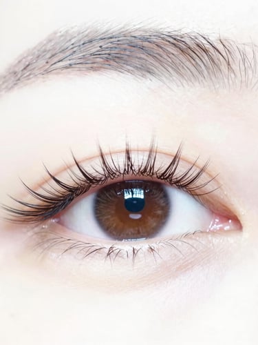 Extreme close-up, macro photography of a single lash extension perfectly isolated on a natural lash, bright studio lighting, crisp detail, minimal white background, 85mm