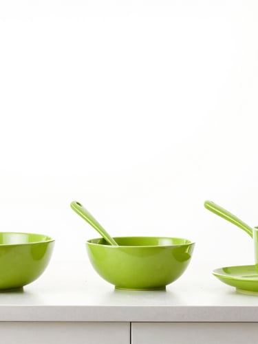 Bright high-key lifestyle photography of a clean modern kitchen counter with kitchenware, soft studio light, sharp focus, 50mm lens