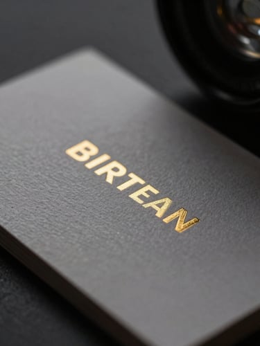 Macro close-up of premium embossed business cards with metallic gold ink, dramatic low-key studio lighting, deep shadows, 35mm lens.