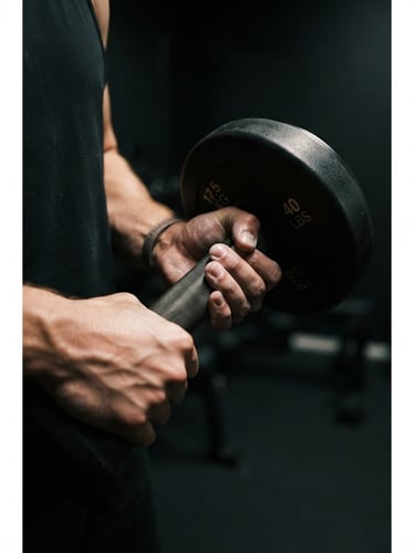 Close-up of a person's hands holding a dumbbell in a dimly lit, minimalist home gym, dramatic side-lighting, deep charcoal tones with warm gold accents, shallow depth of field, 35mm, portrait aspect