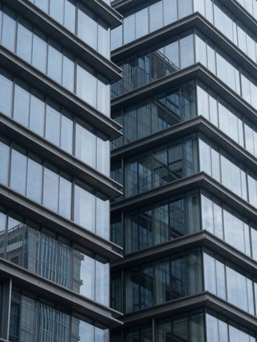 Abstract geometric architectural lines of a modern office building, steel and glass structure, cool blue and slate tones, sharp focus, clean corporate composition.