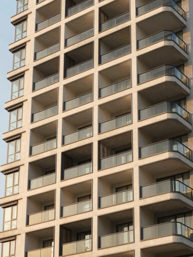 Sleek modern high-rise apartment exterior in Kharadi, Pune, warm golden-hour architectural photography, 35mm lens