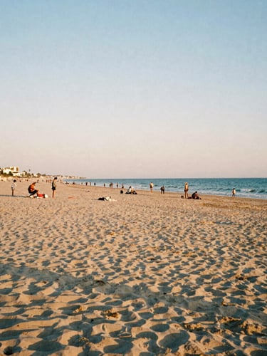 A wide panoramic shot of a quiet beach at dusk in Mar Menor, soft sun-drenched tones, authentic local life, 35mm photography