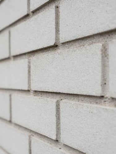 Macro detailed shot of clean modern brickwork and mortar joints, natural overcast daylight, sharp focus, desaturated tones, 35mm
