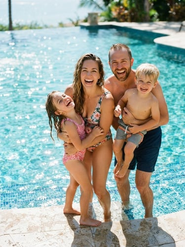 A bright, sunlit portrait of a family laughing by the edge of a sparkling turquoise pool, crystal-clear water reflecting intense midday sunlight, 35mm lens.