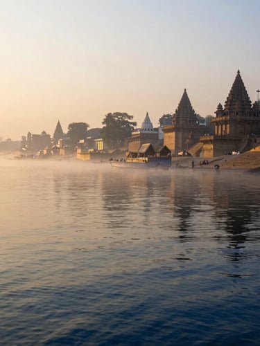 An atmospheric wide shot of the Ganges River at sunrise, soft morning mist hovering over the water, distant silhouettes of ancient temple ghats, golden hour light illuminating the serene riverbank, warm editorial style.