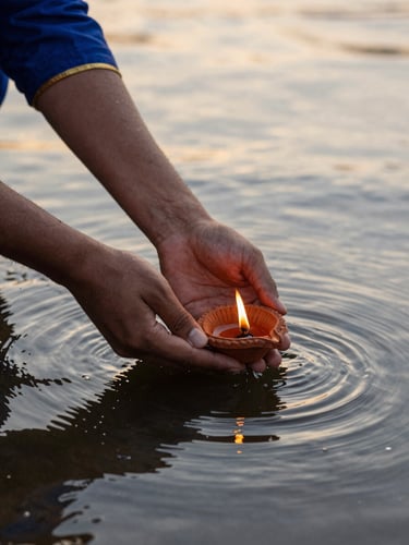 Close-up of gentle hands placing a small terracotta diya with a burning flame onto quiet, dark river water, soft golden light reflecting on the ripples