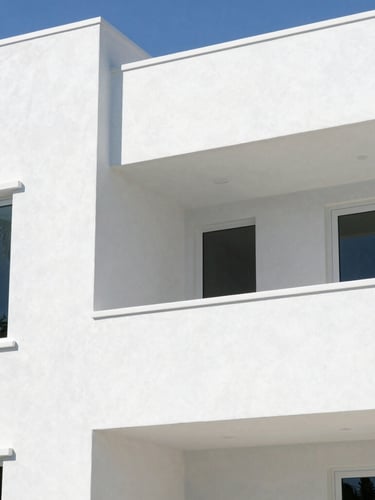 Crisp architectural photography of a modern high-end waterfront home in Boca Raton, showing clean white painted stucco walls reflecting bright midday coastal daylight.