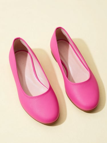 Quirky retro product photography of asymmetrical hot pink flats on a pastel cream surface, vibrant studio lighting, 35mm