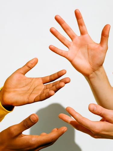 Bright editorial photo of hands gesturing in warm conversation, sunny natural daylight, clean white background, 35mm lens