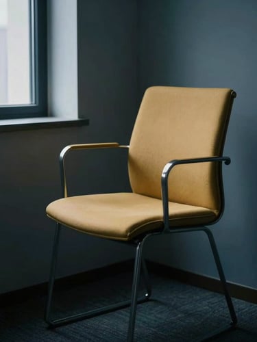 Quiet, contemplative empty chair in a modern, minimalist office corner, soft natural window light, muted deep blue shadows, editorial photography