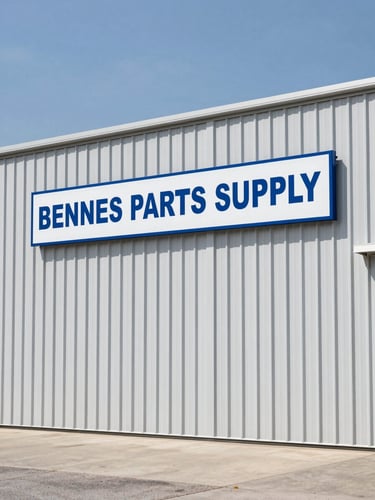 Crisp outdoor shot of the Bennets Parts Supply warehouse exterior, clean industrial metal building with clear signage, bright daylight, Alabama sky