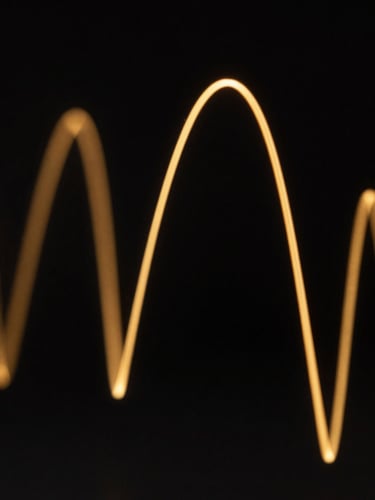 Macro close-up of sharp golden vector lines representing probability curves cutting through a pitch-black background, high contrast, low-key lighting, clean mathematical geometry.