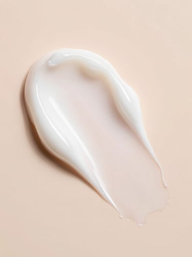 Macro texture shot of a smooth, milky white cream swatch on a soft peach background, diffused high-key morning light, high-end K-beauty aesthetic