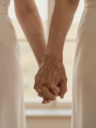 A warm editorial portrait of an elegant elderly couple holding hands, soft natural light reflecting off gold wedding bands, shallow depth of field.