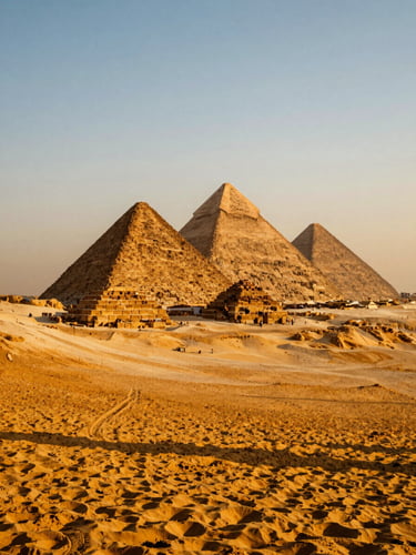Wide cinematic shot of the Pyramids of Giza during golden hour, warm orange sunlight casting long shadows across the desert sand, sharp focus, 35mm composition.