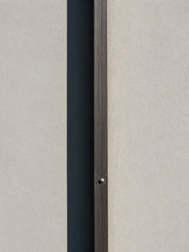 Architectural portrait close-up of a flush wood-to-steel joint under crisp morning sun, sharp shadows, minimalist, 35mm