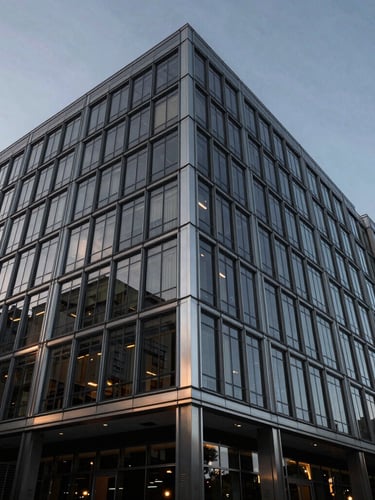 Wide-angle architectural perspective of a modern glass and steel office building in Austin, cool ambient daylight reflecting off metallic accents, deep charcoal tones, high contrast, professional editorial style.