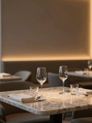 Close-up of a minimalist luxury restaurant interior in Itaim Bibi, warm ambient light catching premium marble surfaces and crystal glassware, soft focus background