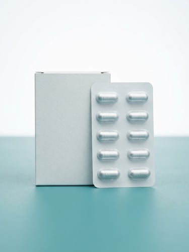 Clean clinical photography of HealBooster medicine packaging on a sterile teal surface, bright high-key studio lighting, sharp focus, 50mm