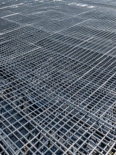 Close-up texture of high-tensile geogrid material weave, sharp focus, clean studio lighting showing structural grid patterns.