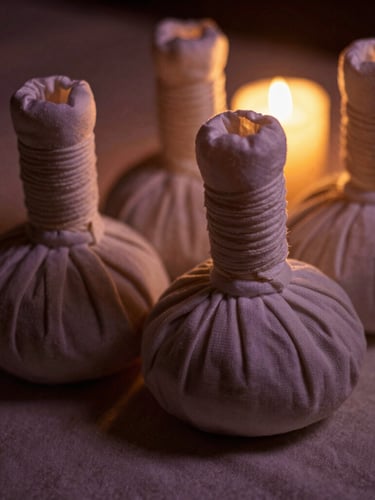 Close-up of warm herbal compresses on textured linen, soft low-key golden candle-glow, 35mm photography