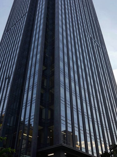 Wide architectural perspective of a modern glass office skyscraper in São Paulo, sharp geometric lines, soft natural daylight, 35mm lens