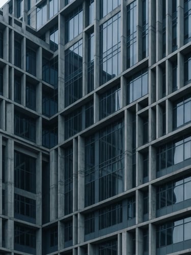 Abstract architectural geometry of a modern concrete and glass building facade in Bengaluru, cool-toned slate gray shadows, diffused morning light, sharp lines.