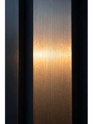 Macro close-up of a high-end brushed metal architectural structure, dramatic side-lighting, rich shadows, warm golden-hour tones, medium format film.