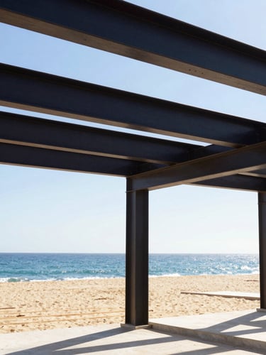 Crisp architectural detail of a luxury house under construction in Cabo, showing heavy steel beams framing the ocean view, bright daylight, warm sand tones