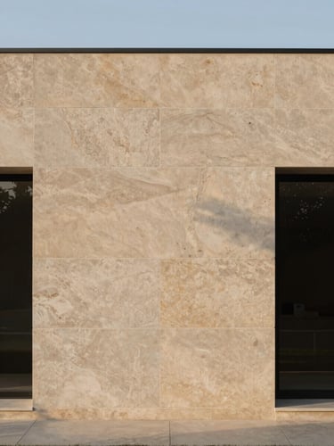 Editorial architectural photography of a minimalist luxury home facade featuring raw stone cladding, soft morning light, medium format.