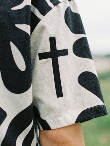 Close-up of a bold organic graphic print on a heavy cotton sleeve, overcast natural daylight, high-contrast details, 35mm film