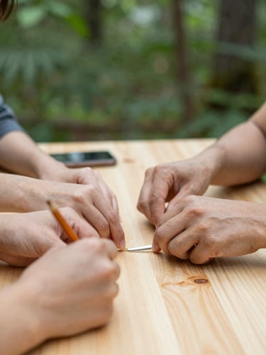 Warm natural daylight illuminating hands working together over a wooden table, collaborative community workshop, soft focus, forest green tones, authentic editorial style