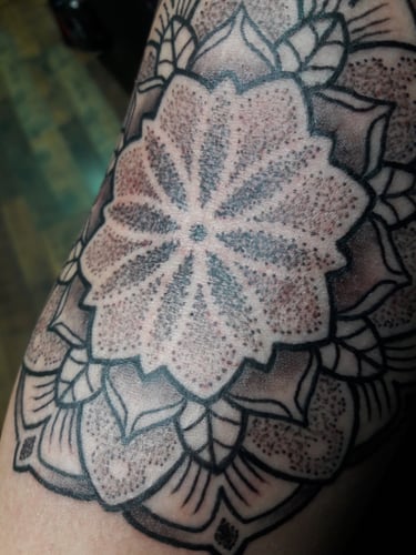 Close up of a dotwork mandala tattoo