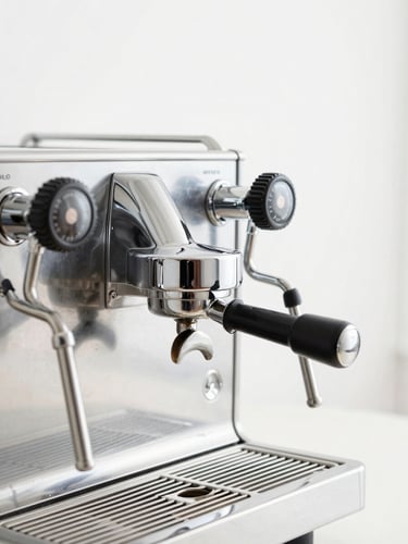 Close-up of a high-end commercial dual-boiler espresso machine, polished chrome finish, steam wand active, minimalist white studio backdrop, bright high-key lighting, sharp focus.