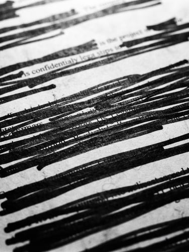 Macro close-up of a redacted corporate filing with black marker lines, harsh overhead light, stark high-contrast monochrome photography, 35mm film grain