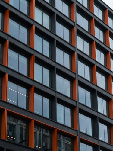 Modern architectural commercial building exterior, crisp daylight, focus on structural lines and clean glass