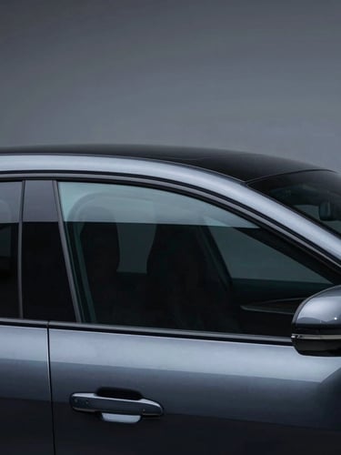 Sleek dark sports sedan side profile, flawless dark ceramic window tint, high-contrast cool studio LED lighting reflecting off clean glass, obsidian paint, macro lens, 35mm