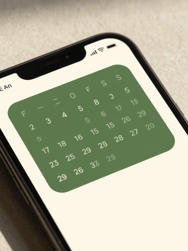 High-fidelity Android device mockup displaying a clean forest-green calendar widget on a warm milk-cream screen, soft morning light, sharp focus.