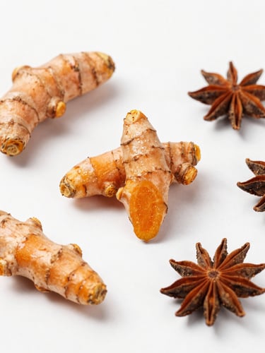 Overhead flat-lay of sorted golden turmeric roots and raw spices on a clean, bright, natural daylight background, sharp focus