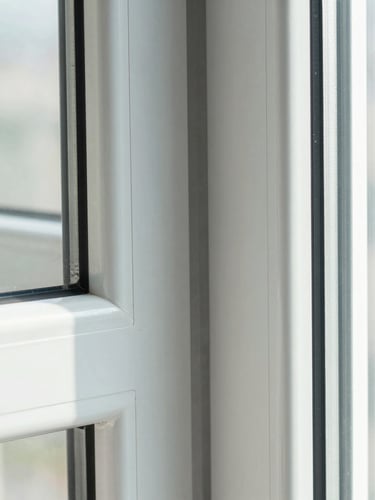 Extreme close-up of a precision-engineered uPVC window corner joint, flawless weld line, clean desaturated cool tones, sharp architectural lighting