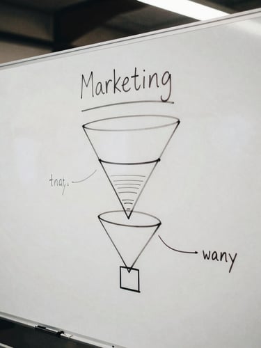 Tight candid crop of a physical strategy whiteboard with hand-drawn marketing funnels in an East London warehouse office, overcast daylight, desaturated high contrast tones, 35mm film.