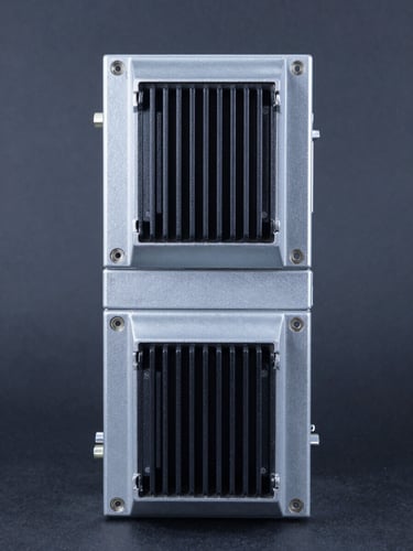 Straight-on technical studio shot of an industrial variable speed drive, clean charcoal background, sharp metallic reflections